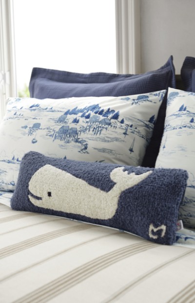 Image of assorted motif pillows on a bed