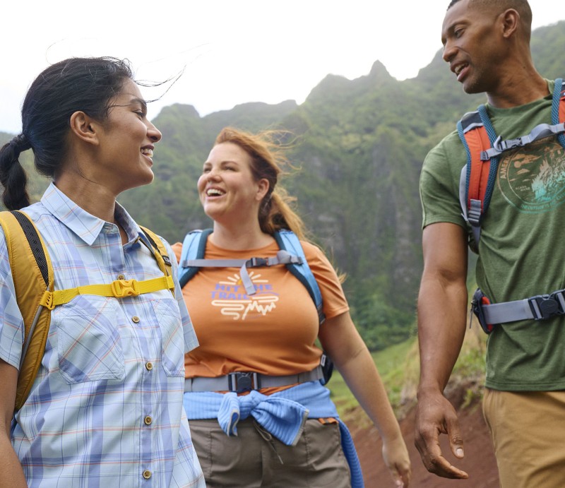 Three people with hiking packs enjoying the outdoors.