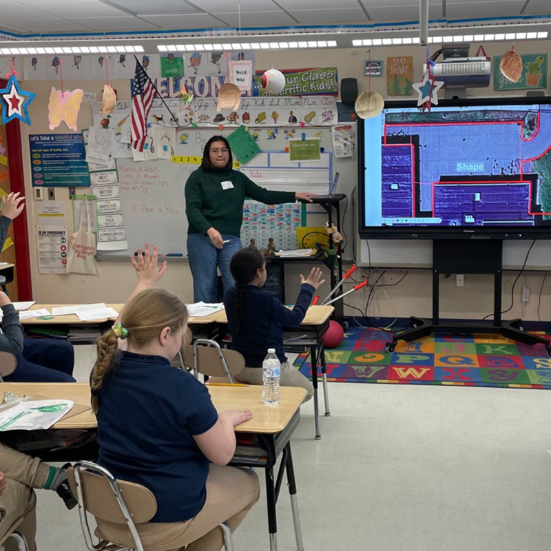 Students and teacher in a classroom.