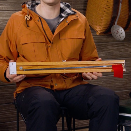 Close-up of a person holding a tip-up.