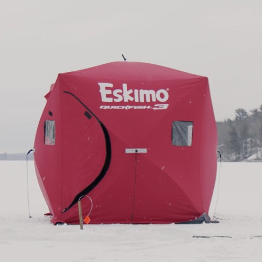 A portable shelter set up on the ice.