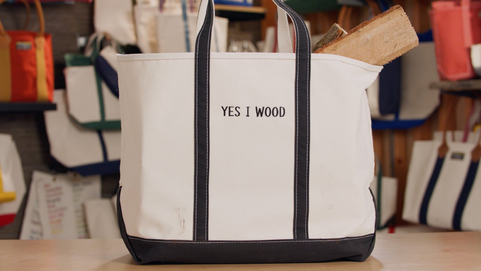 A Boat & Tote with black handles and a black monogram - "YES I WOOD"