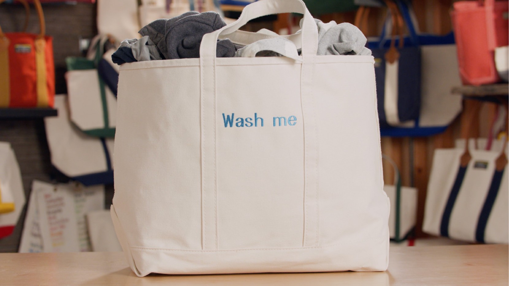 A large all white Boat & Tote with light blue monogram - "Wash me"