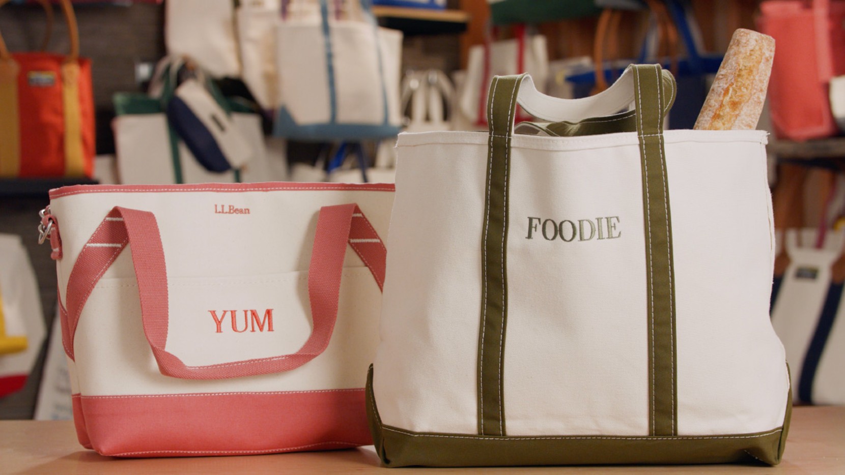 A large Boat & Tote with olive handles and monogram - "FOODIE", and an insulated tote with reddish handles and monogram - "YUM"