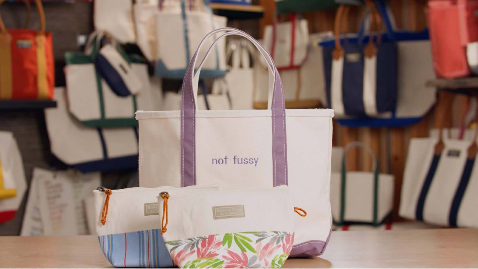 A Boat & Tote with lavender handles and monogram - "not fussy", and 2 Boat & Tote Zip Pouches.