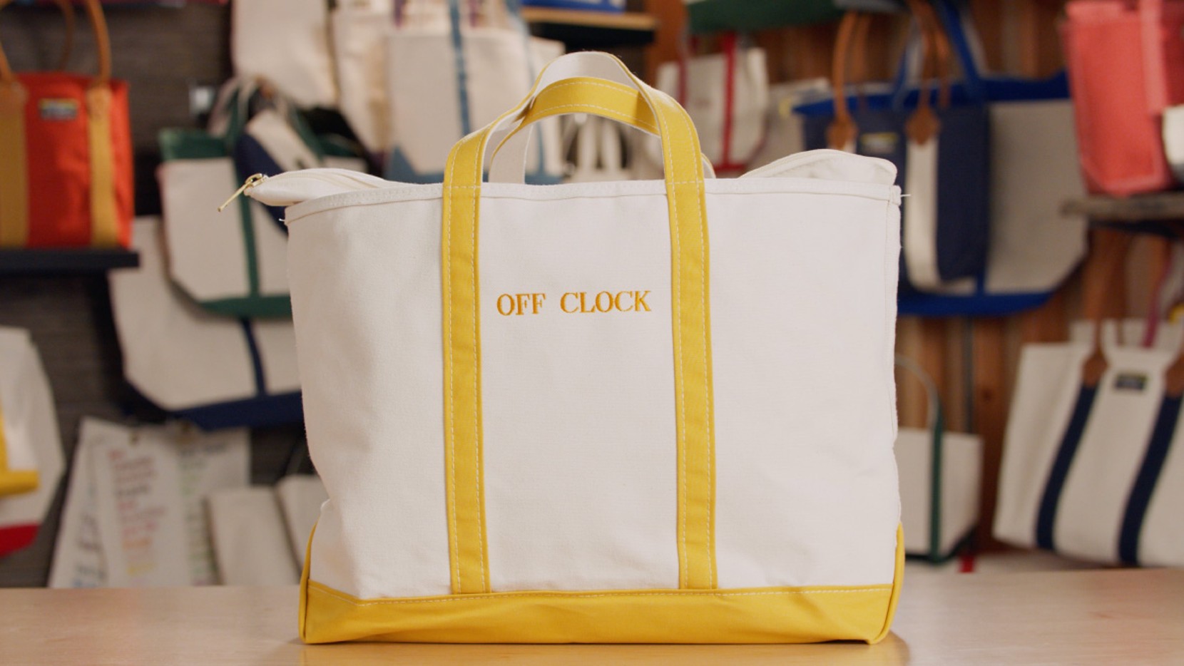 A large zip-top Boat & Tote with yellow handles and monogram - "OFF CLOCK"