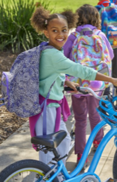 Young girl wearing school backpack