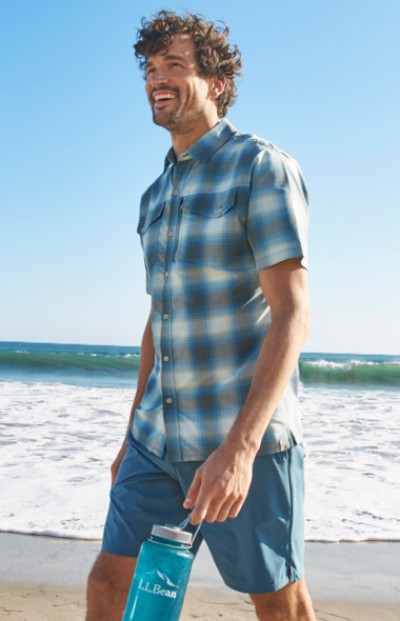 Man walking on the beach, wearing LL Bean activewear.