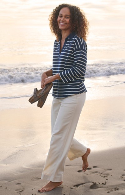 Image of a woman walking on the beach.