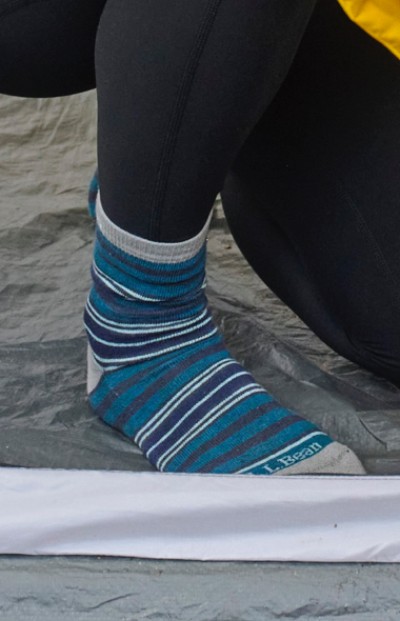 Image depicting a person wearing socks while camping.