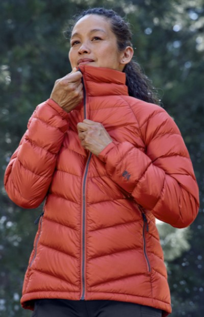 Woman zipping up an insulated jacket.
