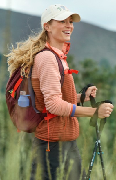 Image of a woman hiking using hiking poles.