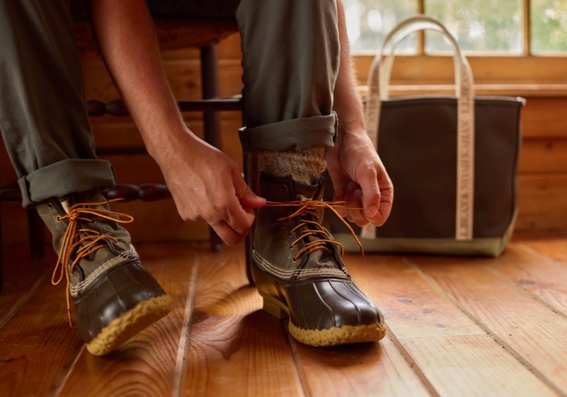 Knee-down shot of someone tying their Bean Boots.