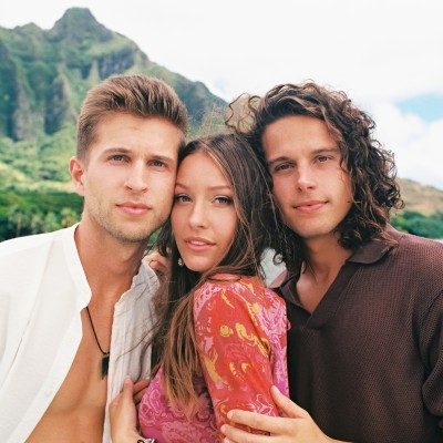 The 3 members of "A Girl Named Tom" band, rocky mountains in the background.