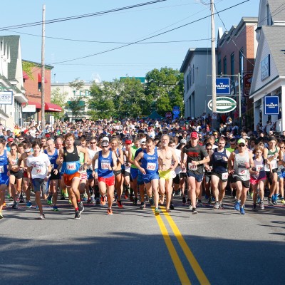 Hundreds of runners at the start line for the 4th of July 10K Road Race.