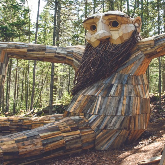 A large wooden troll sculpture at the Maine Botanical Gardens.