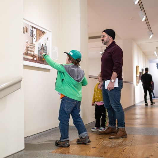 A man with 2 young kids at the Portland Museum of Art.