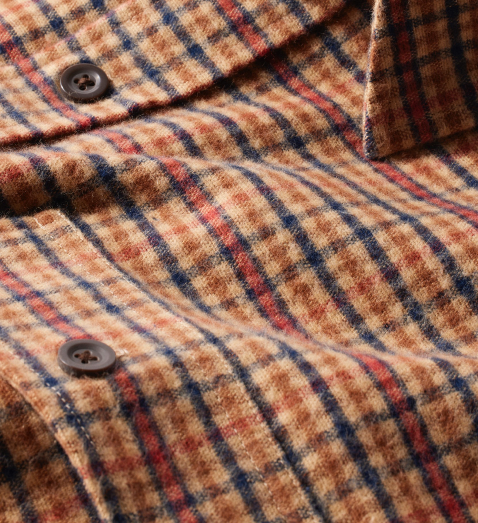 A close-up detail image of a plaid L L Bean Chamois shirt with buttons.