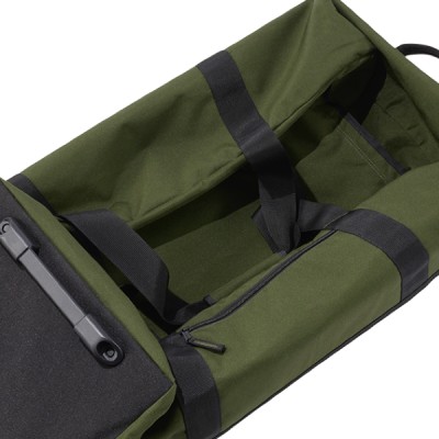 A green, L L Bean duffle fully open and empty, collapsed down, ready for storage.