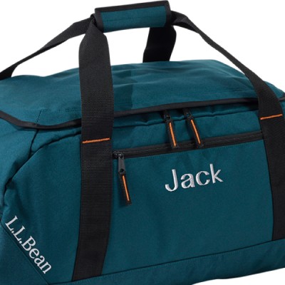A teal L L Bean duffel bag with the name Jack embroidered on it, resting on a surface, ready for an adventure.