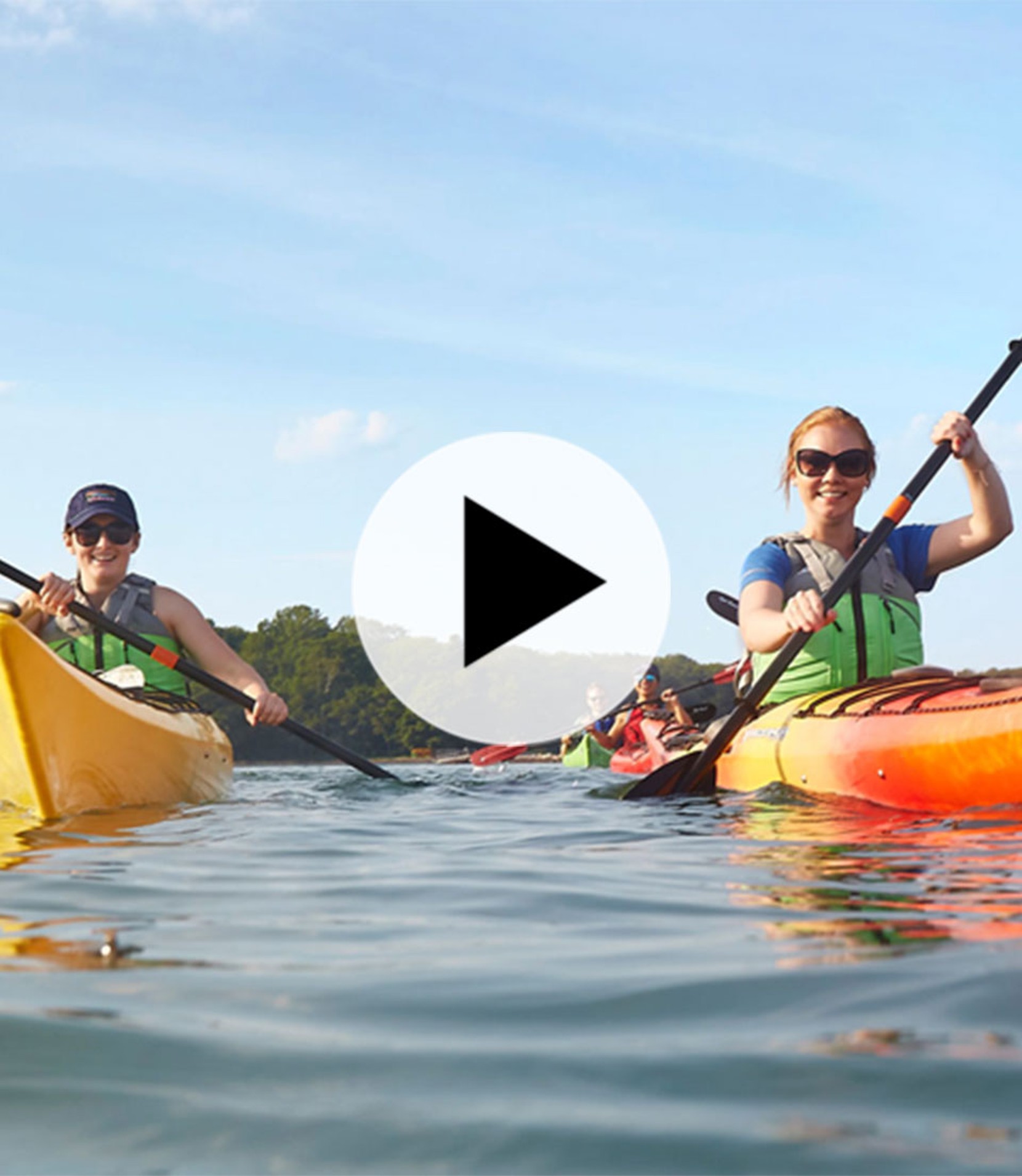 Smiling people kayaking.