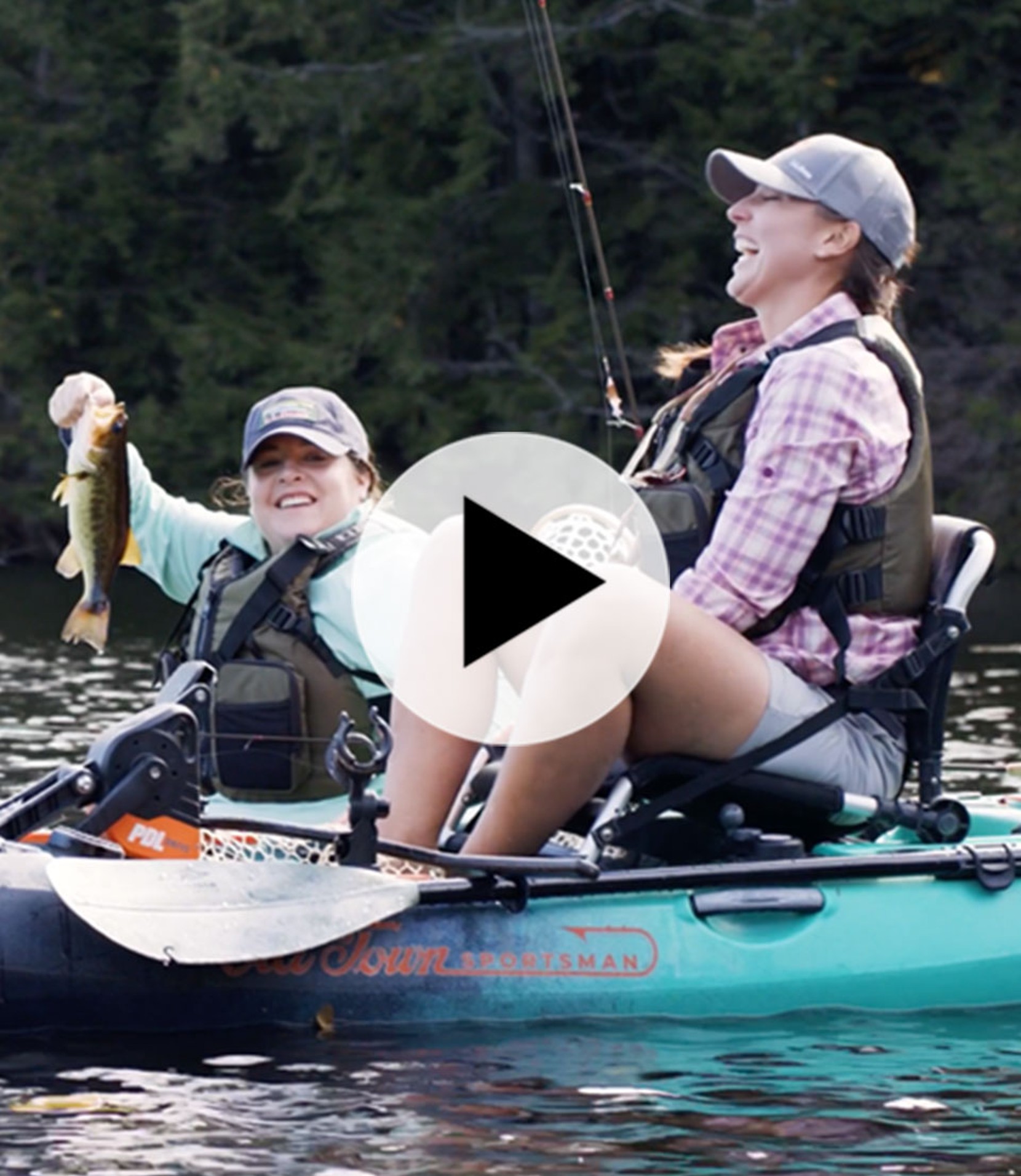 Two women fishing while sitting in kayaks.