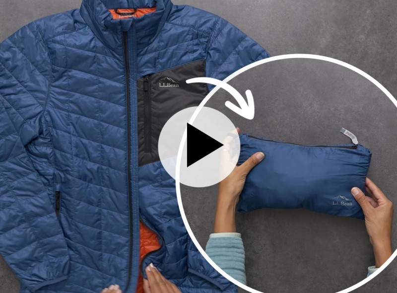 A blue stowaway jacket shown in two different ways: laid out flat and stowed away in it's own pouch.
