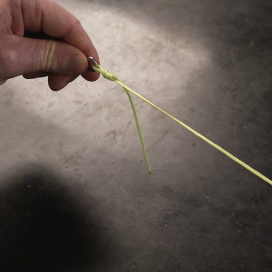 A fishing knot slides down to the fishing hook.