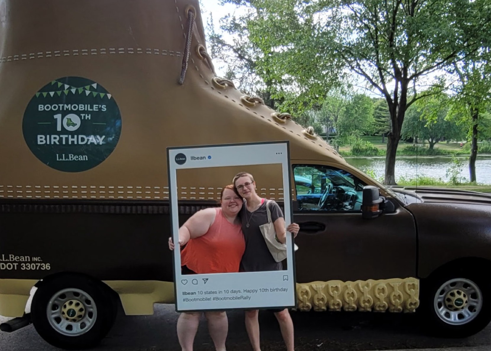 Two people pose with a large boot-shaped vehicle celebrating L.L.Bean's Bootmobile 10th birthday.