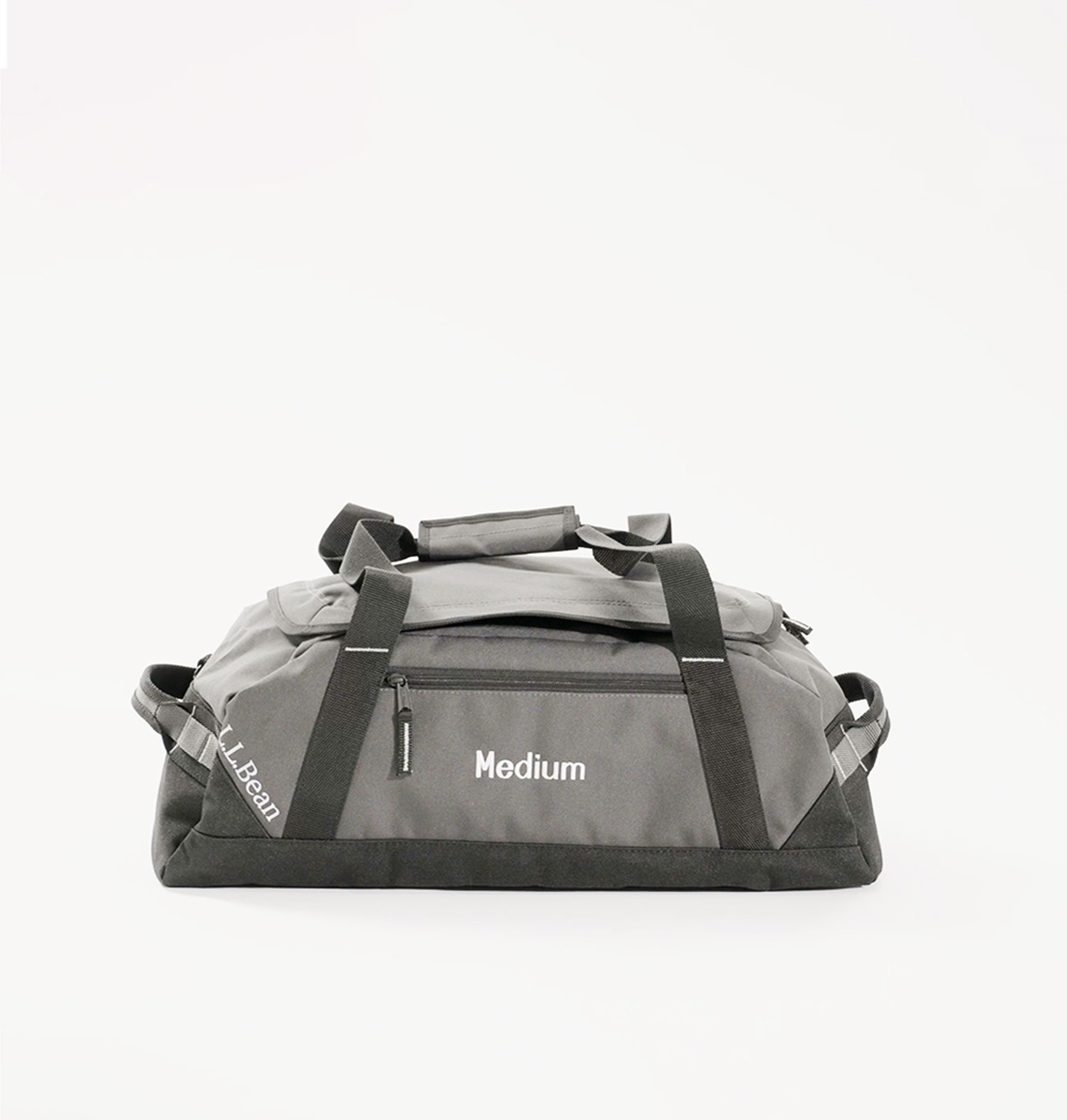 Side view of a medium, gray Adventure Duffle on an eggshell white background.