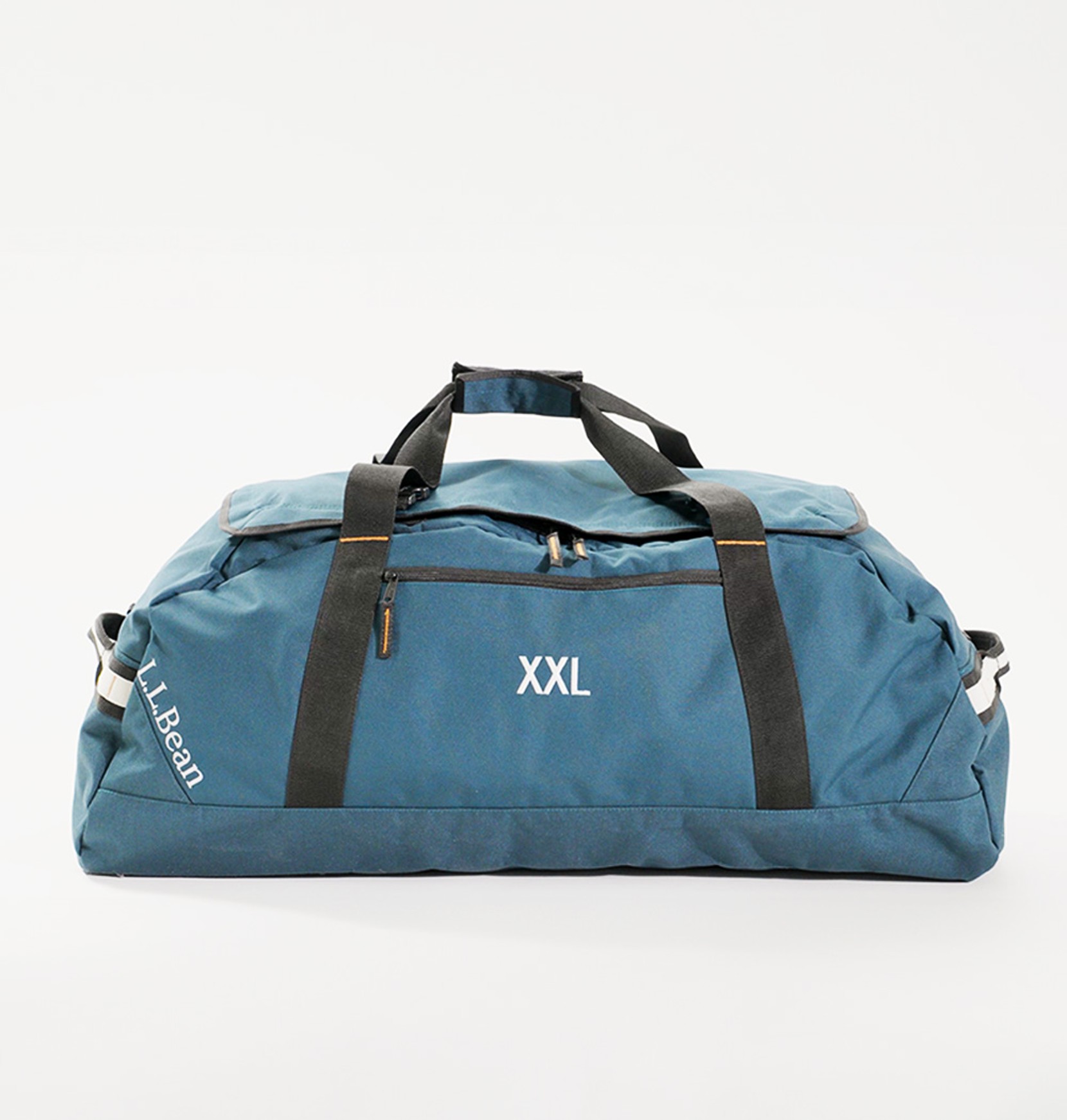 Side view of an extra extra large, teal Adventure Duffle on an eggshell white background.