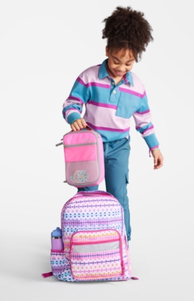 Young girl with coordinating school backpack and lunchbox.