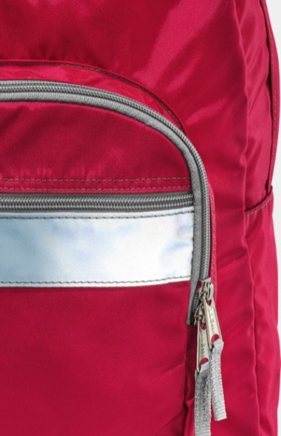 Close up of a red L. L. Bean school backpack showing the wide reflective stripe on the front pocket.