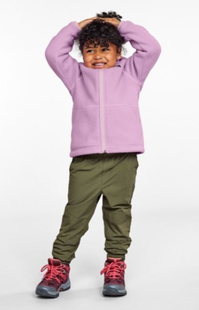 Toddler wearing a light purple zip-up jacket, olive green pants, and gray hiking boots with bright pink laces.