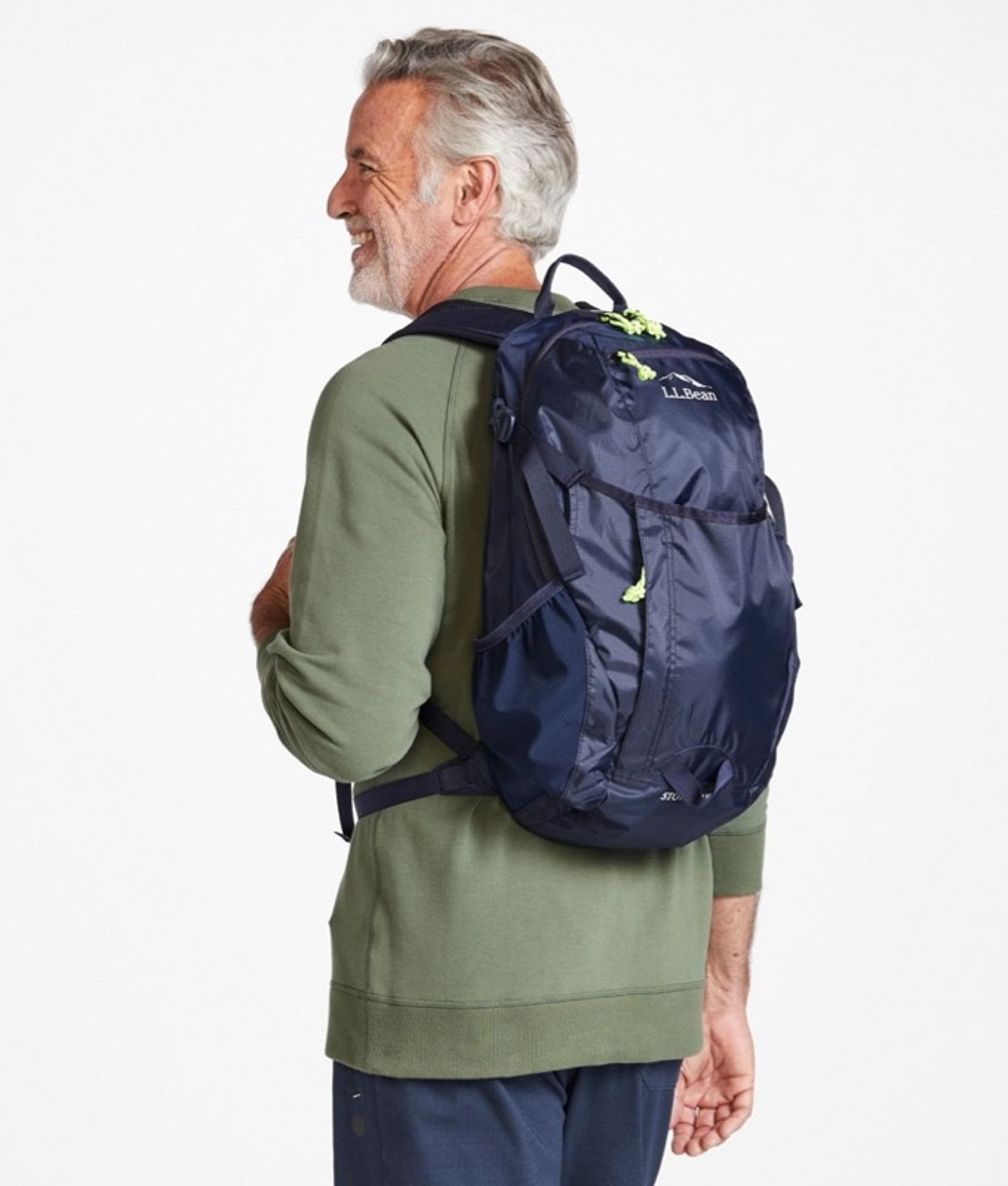 A man wearing a hiking backpack turned away from the camera so the backpack is shown at 3/4 view.