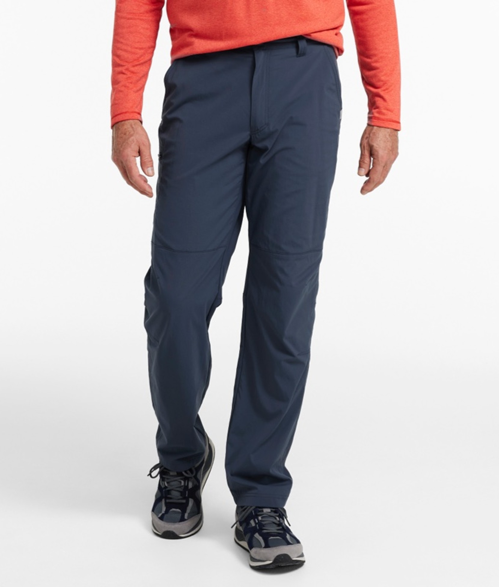 A waist down shot of a man wearing hiking pants.