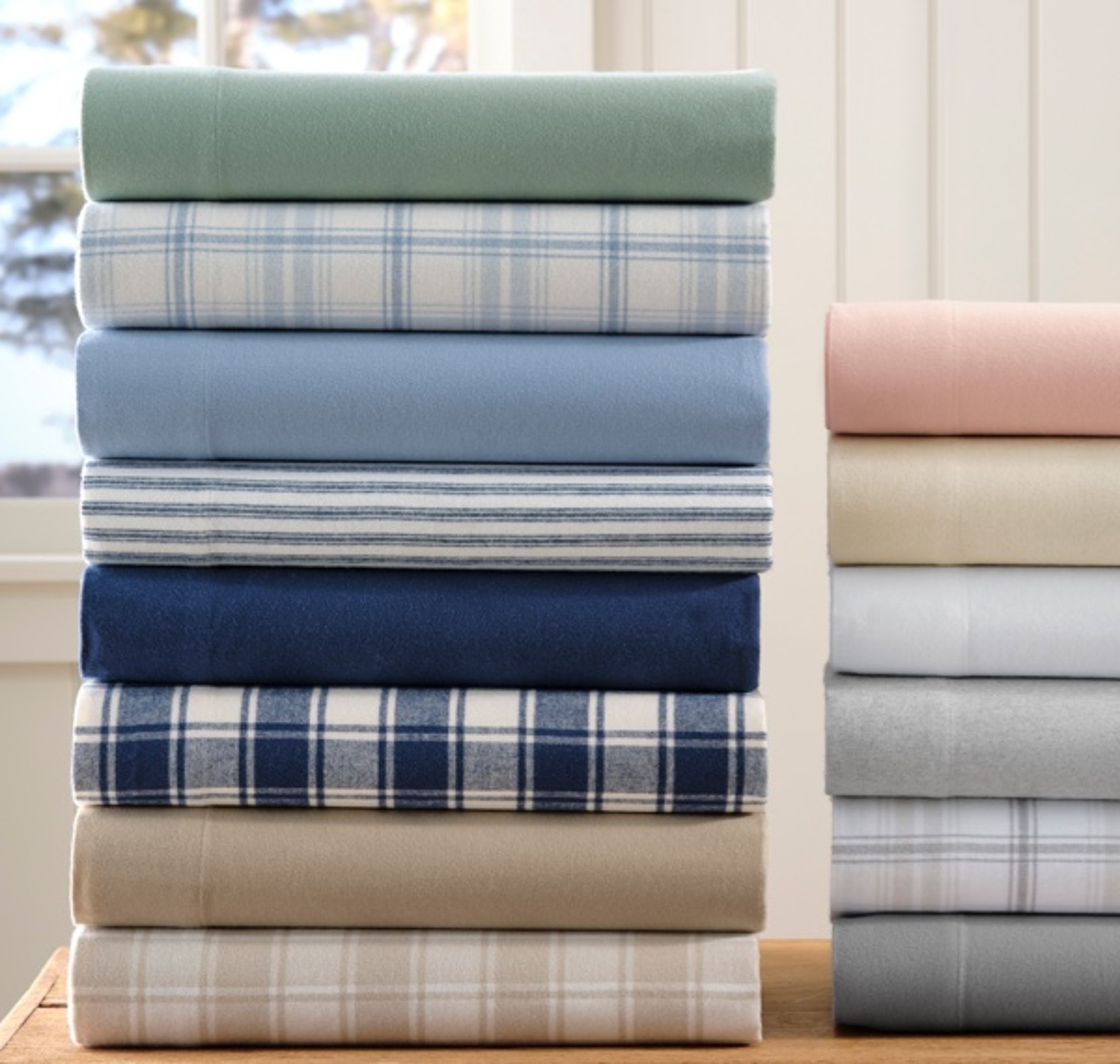 2 stacks of different colored flannel sheets.