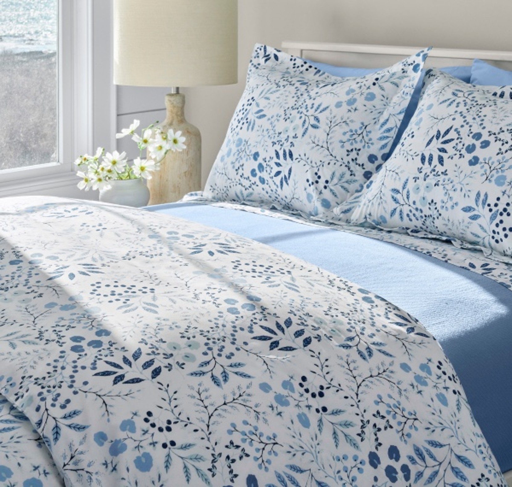 Bed made with floral Percale Sheets.