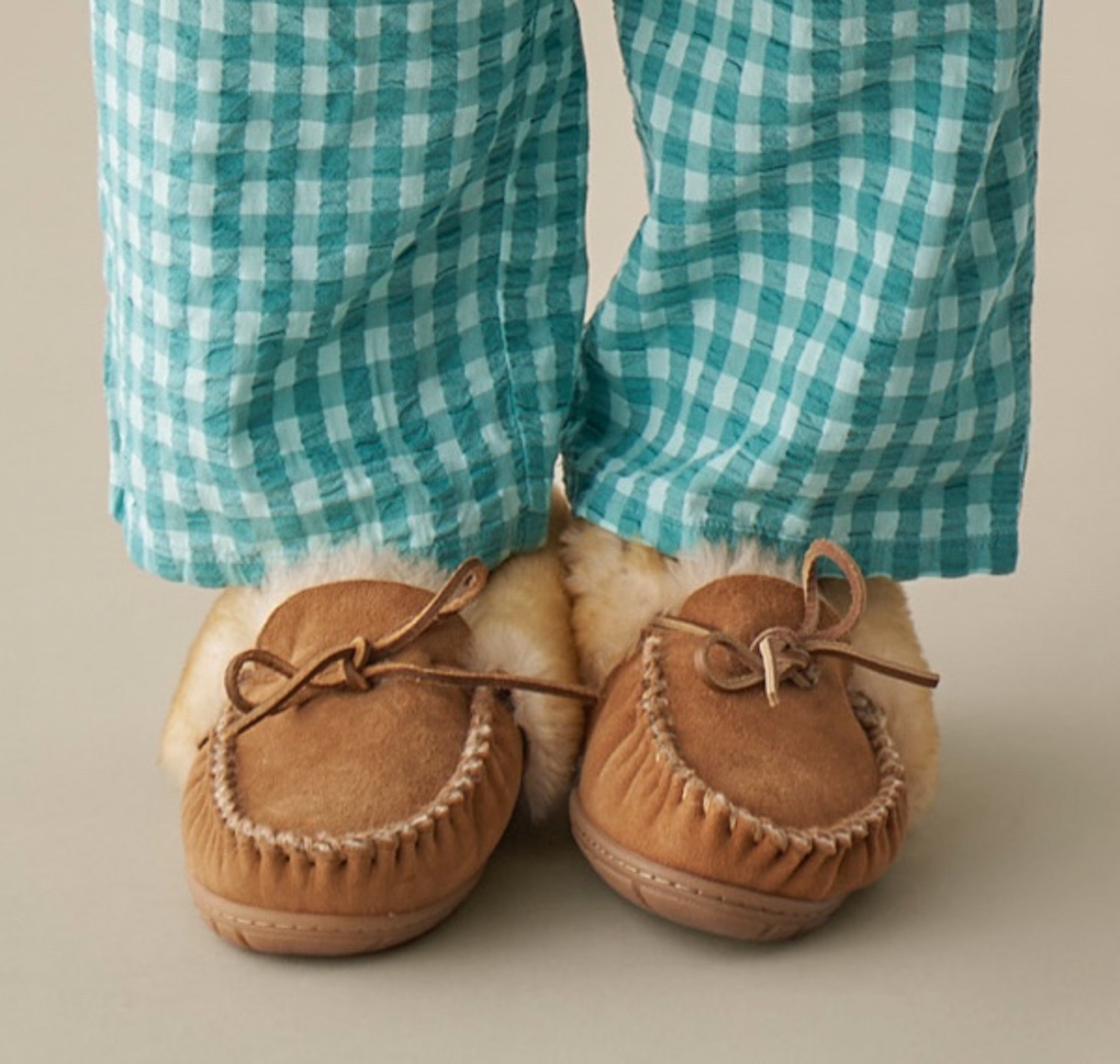 Shin down shot of a woman wearing pajama bottoms and Wicked Good Slippers.