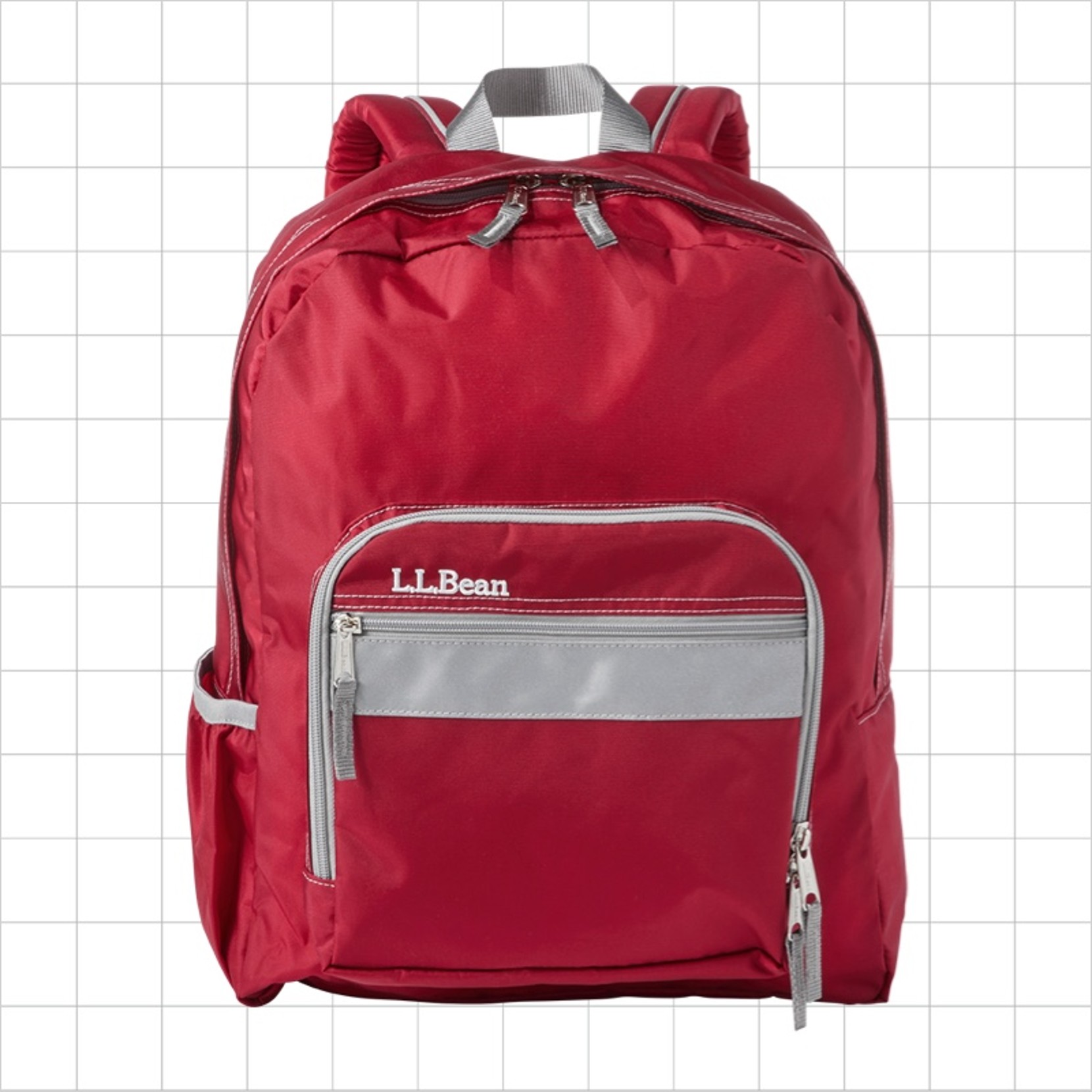 A red school backpack with a reflective strip on the front pocket.