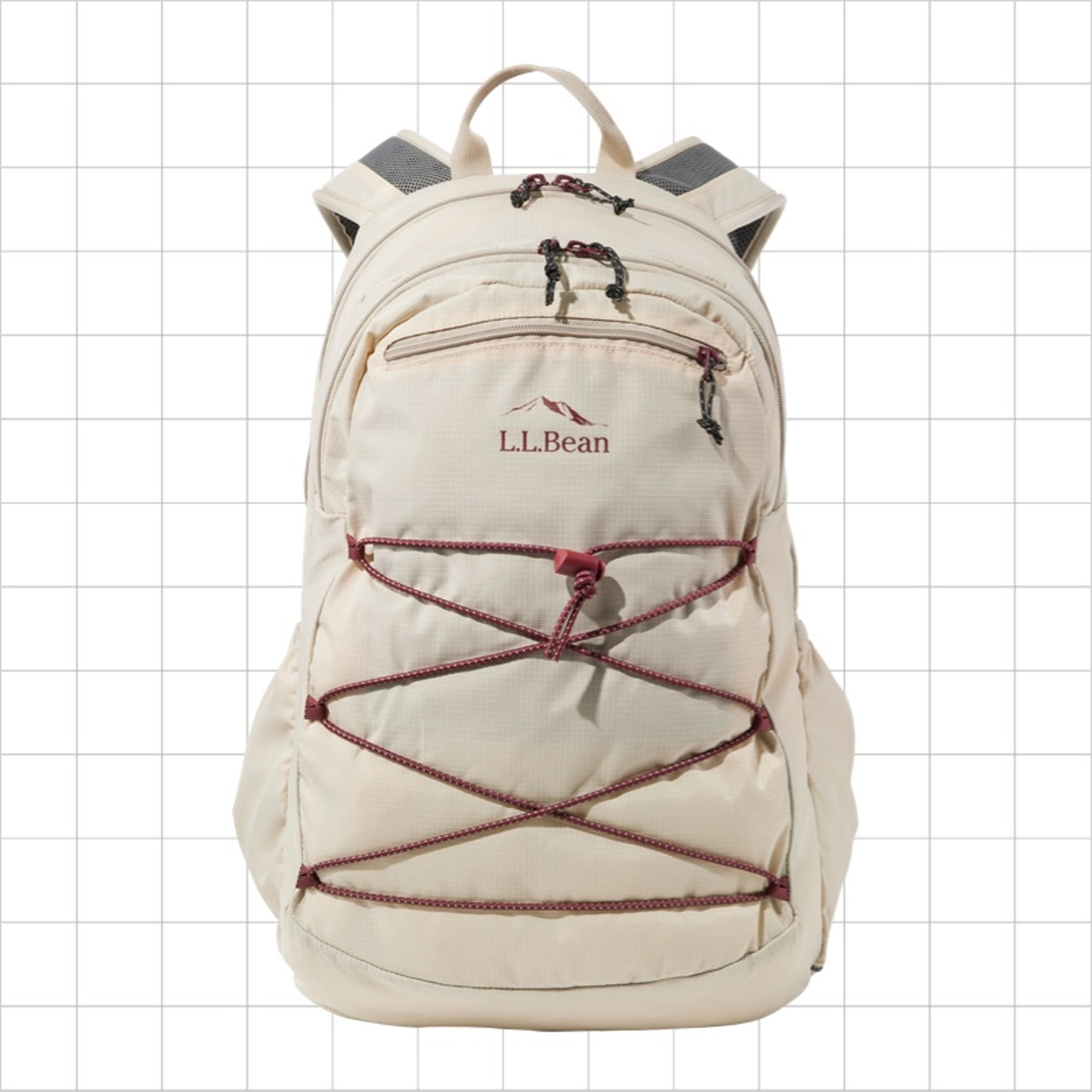 A cream-colored school backpack with a criss-cross cord strap on the front.