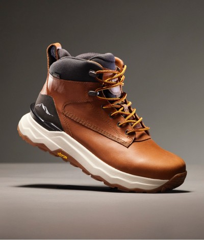 Brown leather hiking boot with yellow laces, black ankle padding, and white sole, shown angled on a gray background.