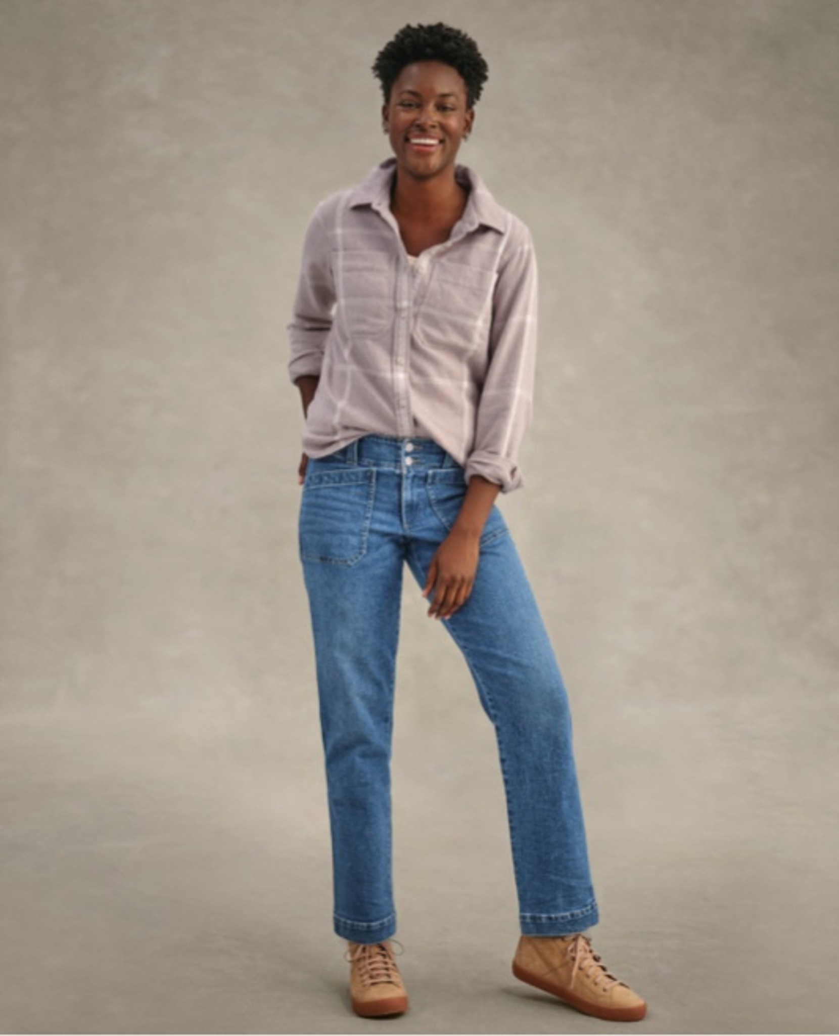 Person stands with hands in pockets wearing light shirt and jeans.