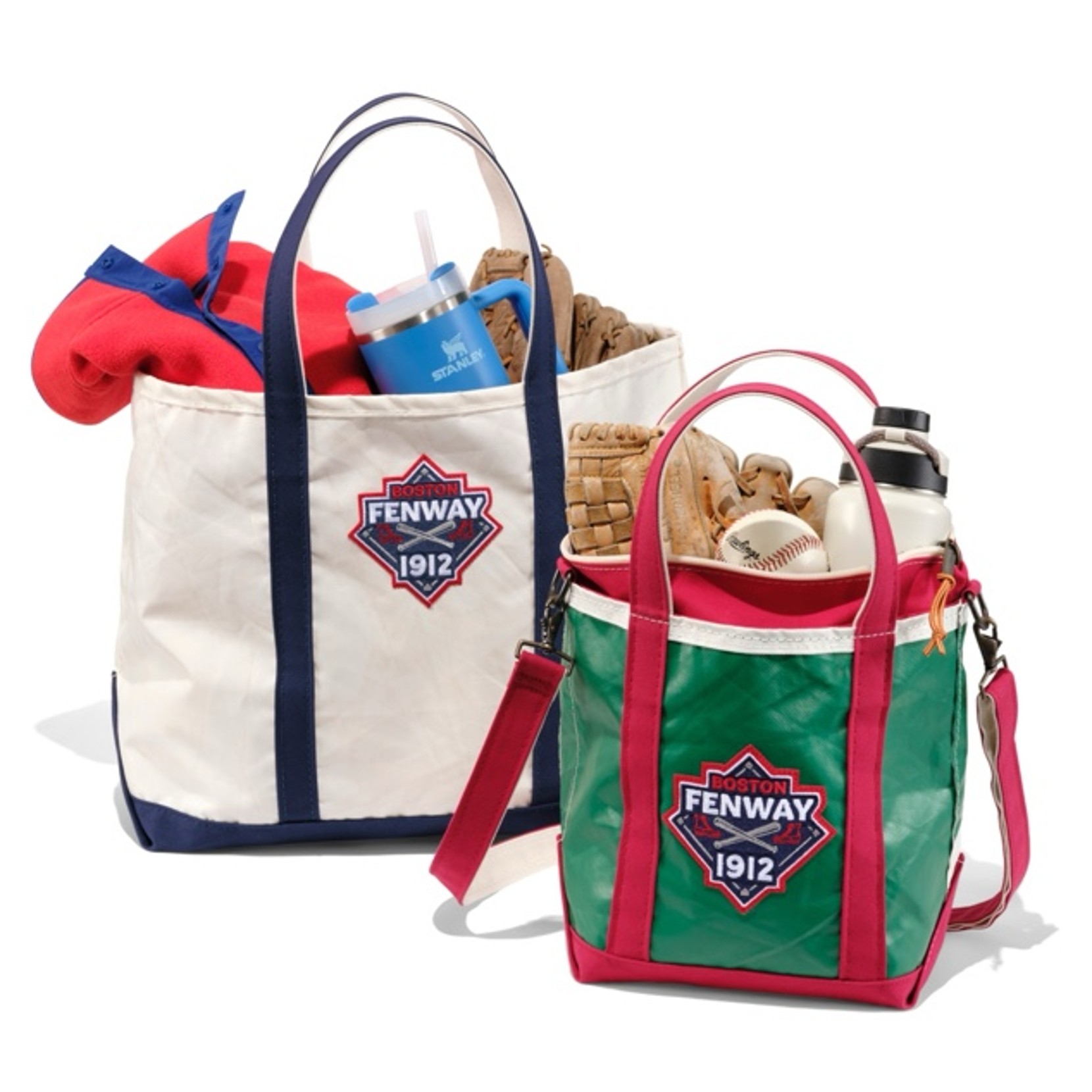 Two tote bags with 'Boston Fenway 1912' logos, one with a blanket and cup, the other with baseball gear.
