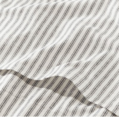 A close up detail shot of gray and white flannel bed sheet.