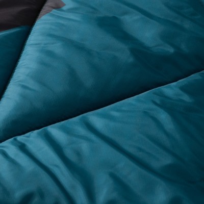 A teal blanked with a quilted pattern, featuring diagonal stitching and a shiny texture.