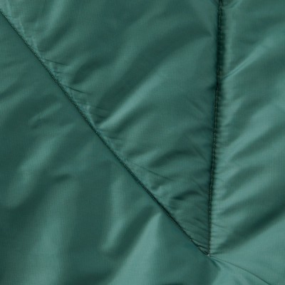 A green blanked with a quilted pattern, featuring diagonal stitching and a shiny texture.