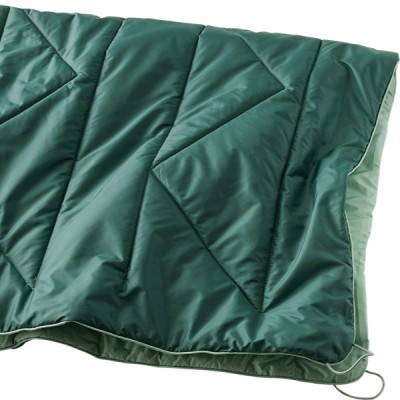 A blanket with a geometric pattern, featuring green and mint green sections. 