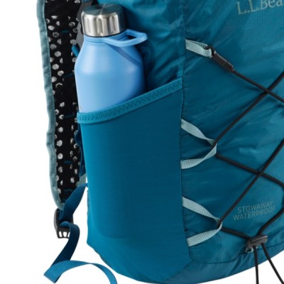 A blue backpack with a water bottle in the side pocket and L L Bean and Stowaway Waterproof text visible.