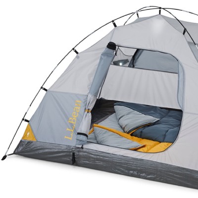 Gray and yellow L L Bean tent with an open door, showing a sleeping bag inside. 